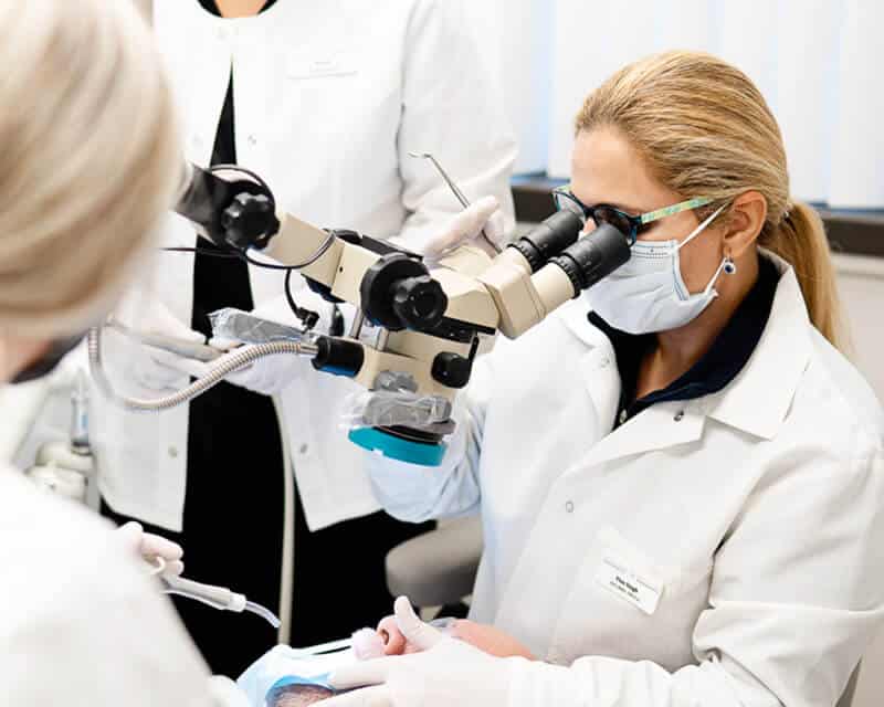 Dr Singh looking through microscope