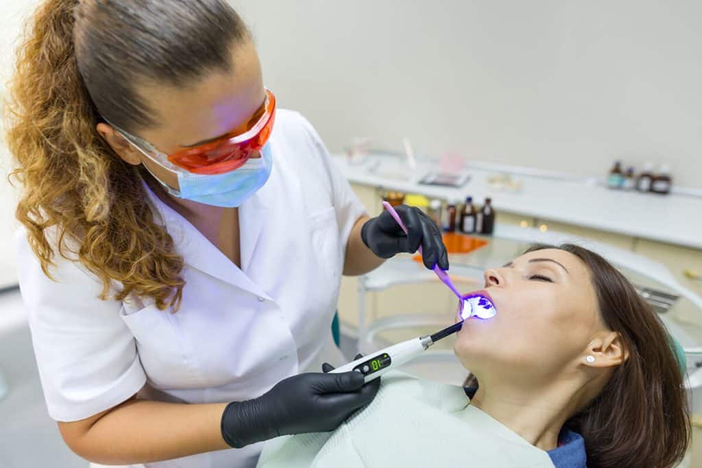 a dentist performs a procedure on a relaxed patient