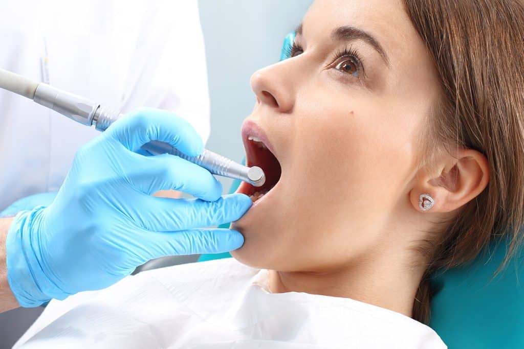 a dentist works on a patient